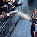Clint Bowyer sprays champagne on the fans