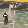 NASCAR fan clinbs the fence at Charlotte Motor Speedway