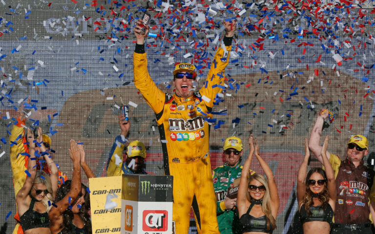 Kyle Busch and the Monster Energy Girls in victory lane at ISM Raceway - NASCAR Cup Series