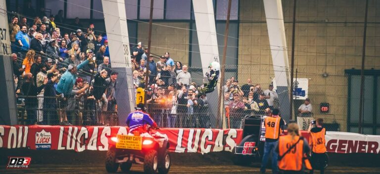 Rico Abreu climbs the fence after the Chili Bowl Nationals win