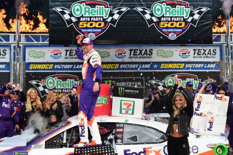Denny Hamlin in NASCAR victory lane with the Monster Energy Girls