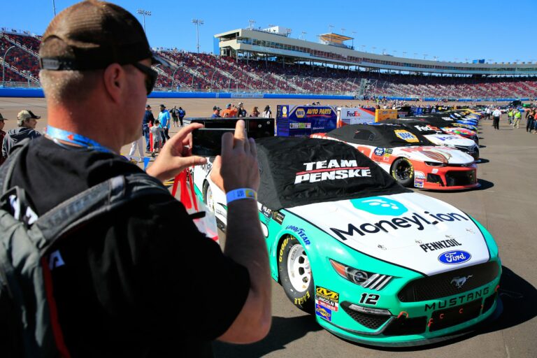 NASCAR fan takes pictures ahead of the start at ISM Raceway