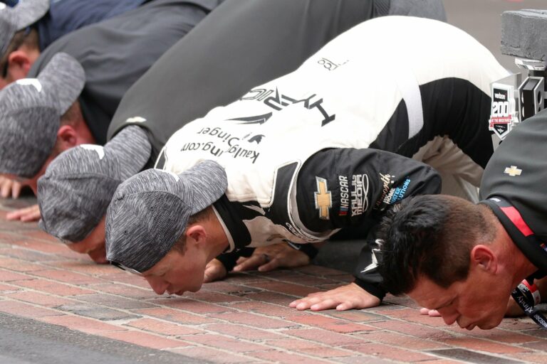AJ Allmendinger kisses the bricks at the Indianapolis Motor Speedway Road Course - NASCAR Cup Series